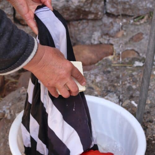 washing t-shirt by hand in wash basin
