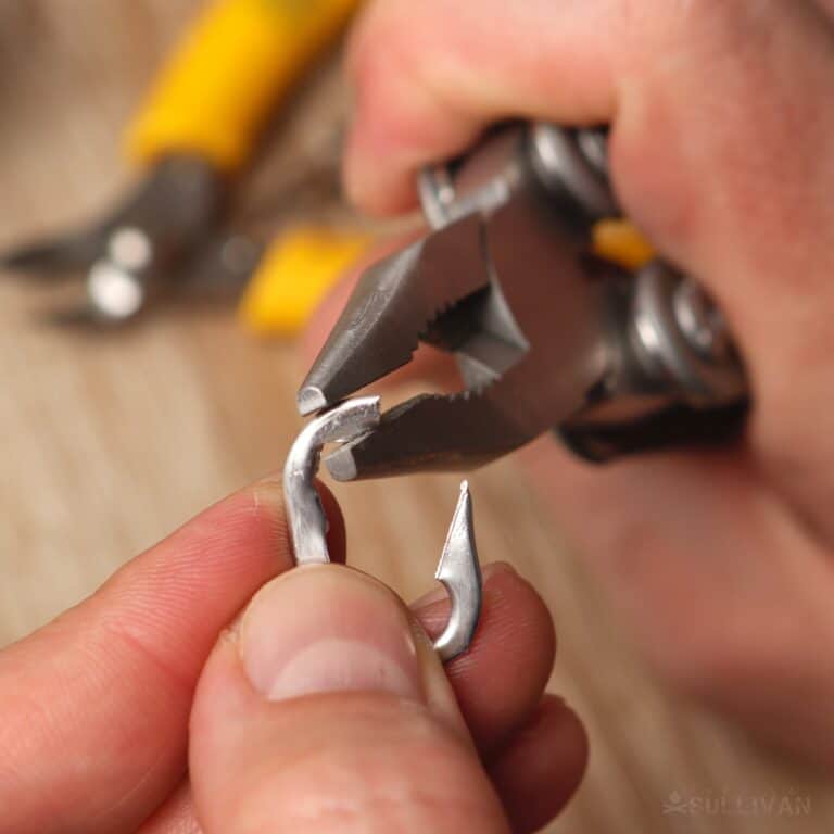 adjusting the tab with pliers