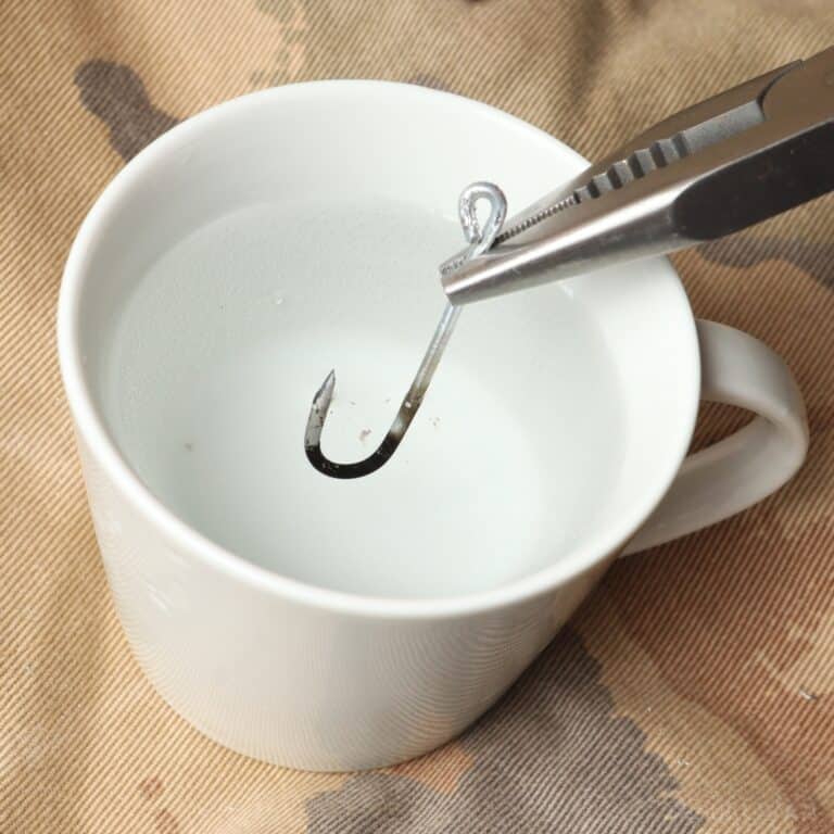 dipping heated wire hook in cup of water