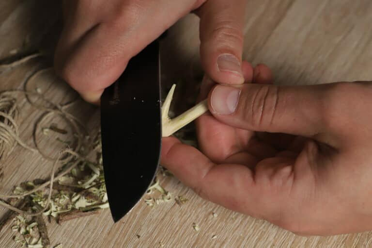 sharpening wooden hook with knife
