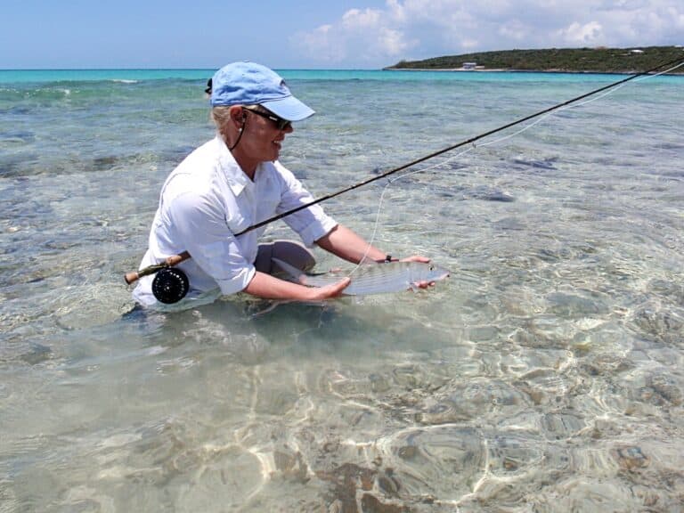woman holding in hands a fresh caught bonefish