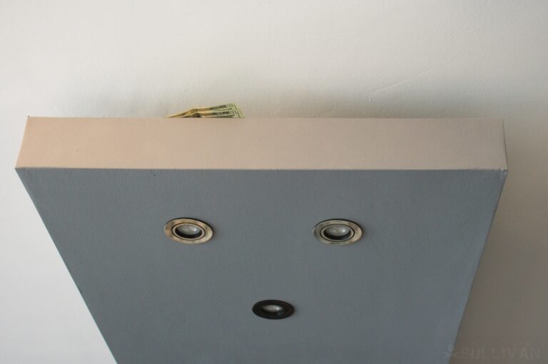 cash hidden between kitchen lights and ceiling