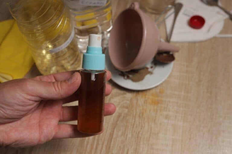 small bottle of DIY pepper spray in hand