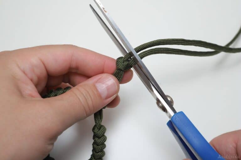 snake knot paracord bracelet cutting the tails with scissors