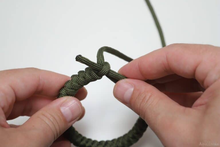 snake knot paracord bracelet passing second free end through pinhole loop