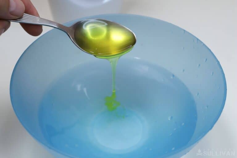 adding dish soap to bowl of water