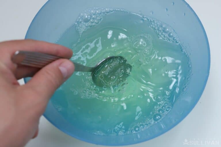 mixing dish soap with water in bowl