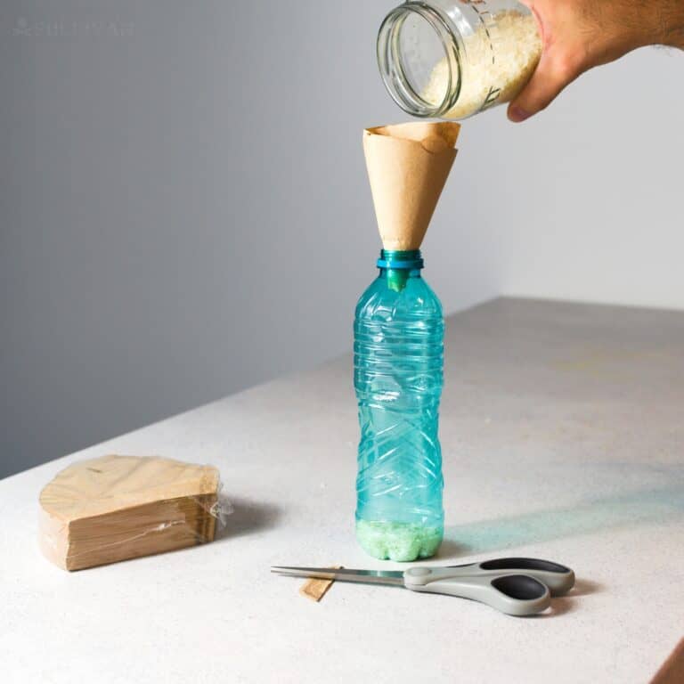 pouring rice into bottle with coffee filter funnel