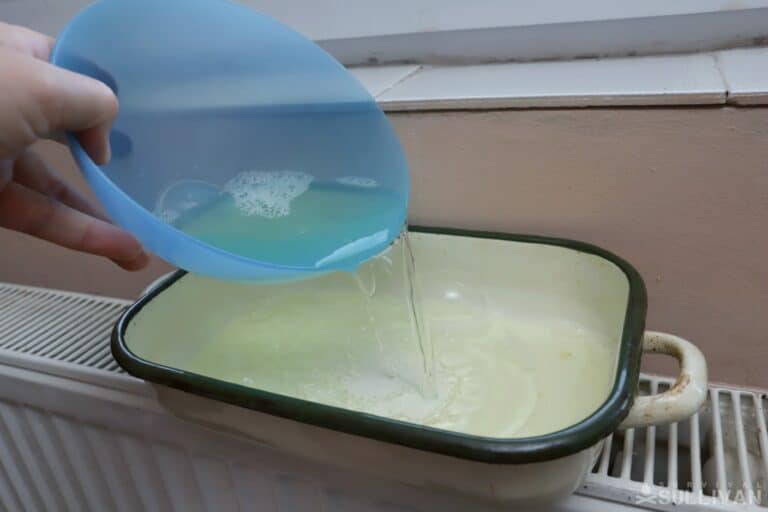 pouring water from plastic to metal container