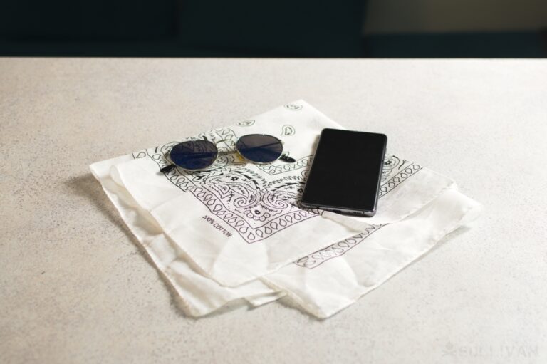 sunglasses and phone over bandana