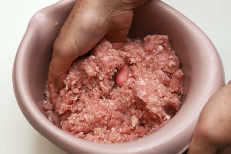 mixing meat with curing solution