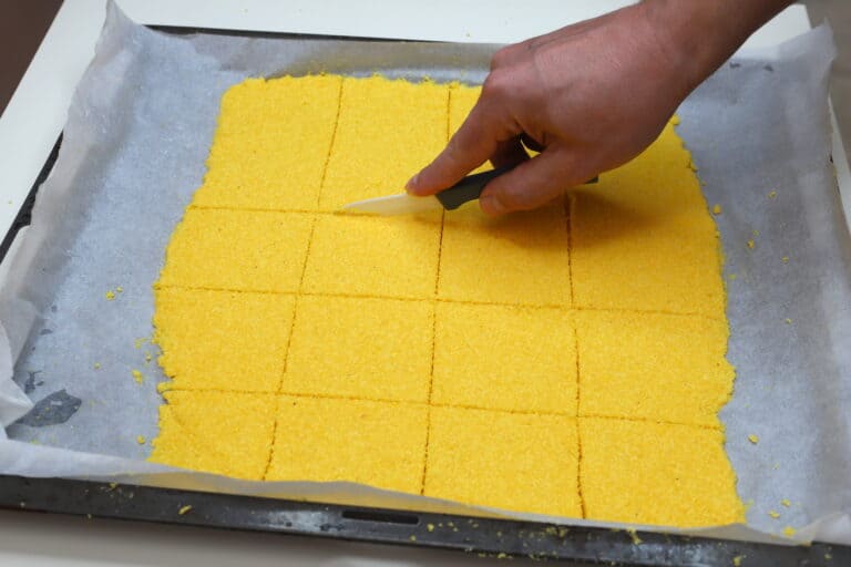 slicing dough into squares with knife