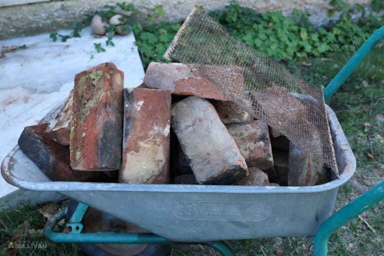 bricks and metal mesh in wheelbarrow