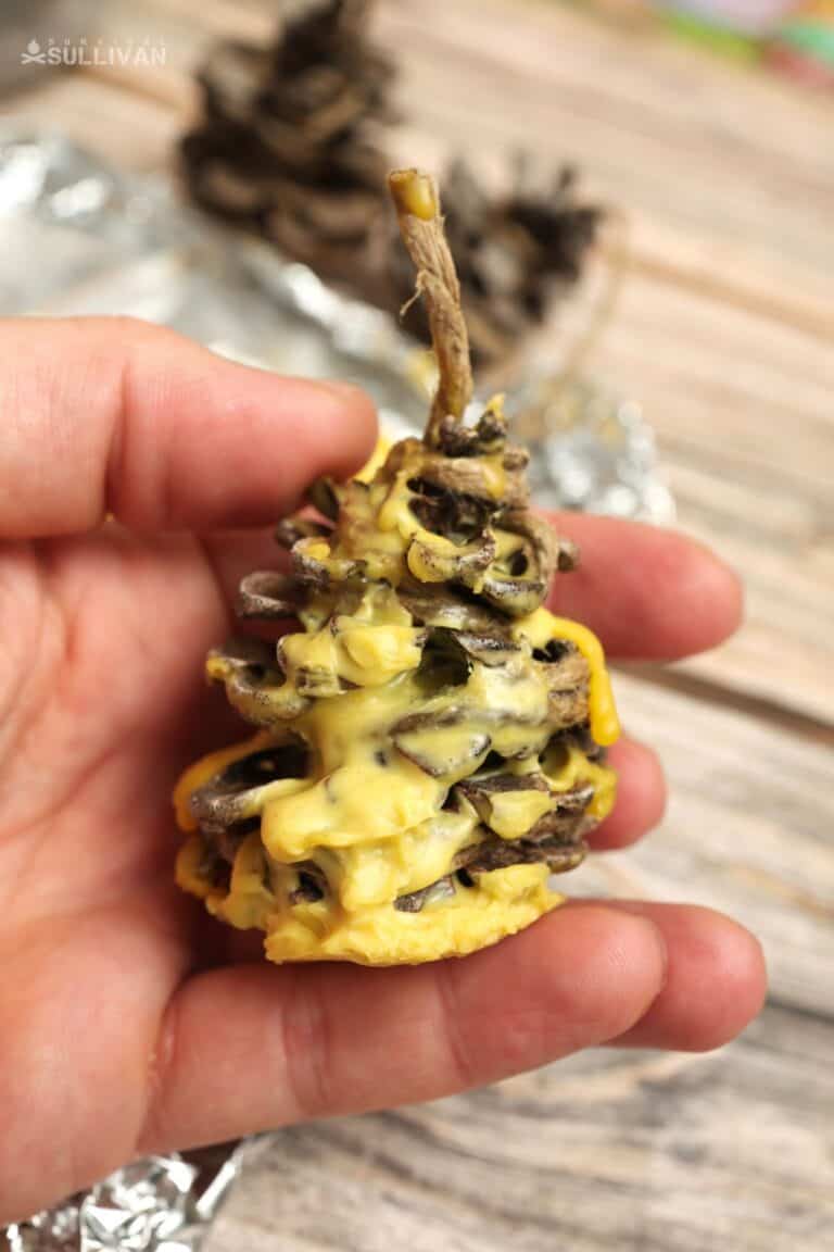 holding beeswax fire starter in hand