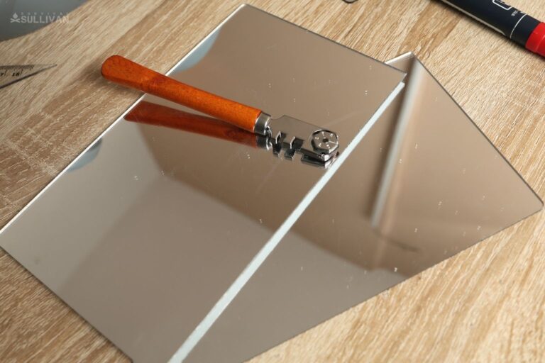 two pieces of mirror and glass cutter